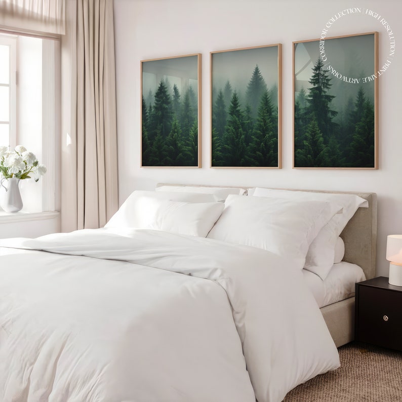 K&ouml;nnte beinhalten: Ein wei&szlig;es Bett mit einem wei&szlig;en Bettbezug und zwei wei&szlig;en Kissen. Drei gerahmte Drucke einer nebeligen Waldszene h&auml;ngen an der Wand hinter dem Bett.