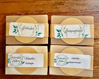May include: Four bars of handmade soap with labels. The labels are decorated with floral designs and have the following text: Lavender, Lemongrass, Vanilla orange, and vanilla peppermint.