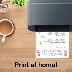 May include: A printer is shown printing a "Weird but True Winter Trivia Game" sheet. The game sheet has a snowman graphic and trivia questions. A cup of coffee and a small plant are on the wooden surface.