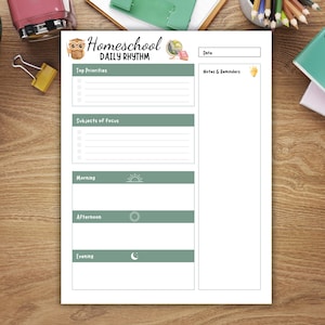 May include: A white Homeschool Daily Rhythm planner with green accents. The planner includes sections for top priorities, subjects of focus, and a daily schedule divided into morning, afternoon, and evening. The planner also has a section for notes and reminders.