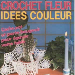May include: A magazine cover featuring crochet projects. The title reads "CROCHET FLEUR IDEES COULEUR". The image showcases a cactus in a crocheted swan planter, a candle holder, and decorative boxes. The text "Cache-pot et porte-bougeoir pour égayer votre table" is also visible.