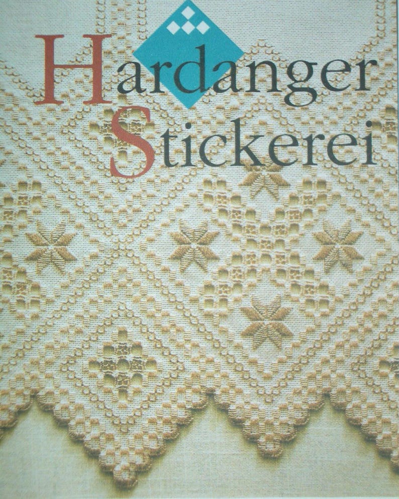 May include: A cream-colored fabric featuring intricate Hardanger embroidery with geometric diamond patterns, star-shaped motifs, and a scalloped edge. The text Hardanger Stickerei is printed in dark lettering over a blue diamond-shaped graphic.