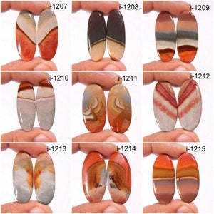 May include: Nine pairs of oval-shaped, polished, colourful, agate cabochons. Each pair is labelled with a number from i-1207 to i-1215.