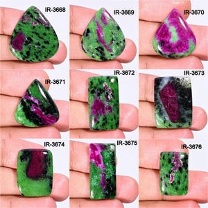 May include: Nine green and pink gemstone cabochons, each with a unique pattern of green, pink, and black. The cabochons are labeled with the numbers IR-3668 through IR-3676.