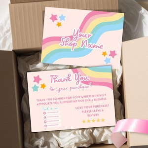 May include: Two pastel pink cards with rainbow and star designs are inside a cardboard box. The top card reads "Your Shop Name." The bottom card says "Thank You for your purchase!" and includes social media icons.