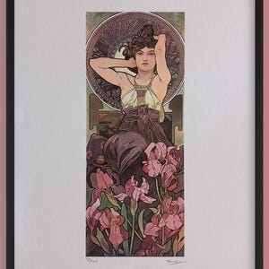 May include: Framed art print depicting a woman with her arms raised, surrounded by flowers. The artwork has a vintage style with a colour palette of browns, greens, and pinks. The print is in a black frame.