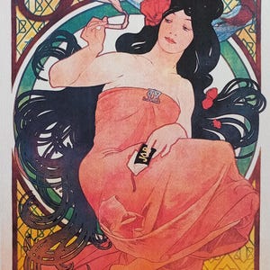 May include: Art Nouveau print depicting a woman in an orange dress, holding glasses and a card with the word "JOB". The artwork has a circular design with floral and geometric patterns, and the artist's signature is visible.