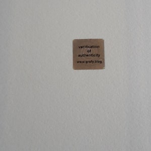 May include: A brown paper sticker with the text "verification of authenticity www.grafy.blog"