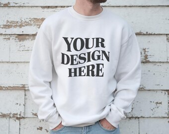 May include: White crewneck sweatshirt with the text "YOUR DESIGN HERE" printed in black on the front.