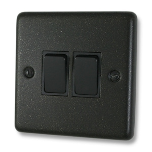 May include: A black double light switch with a textured finish. The switch has two black toggle buttons.