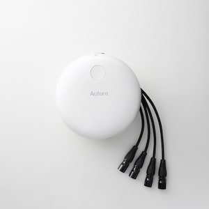 May include: A white, circular device with the word "Auturo" printed on it. Four black cables with connectors extend from the device. The device is set against a white background.