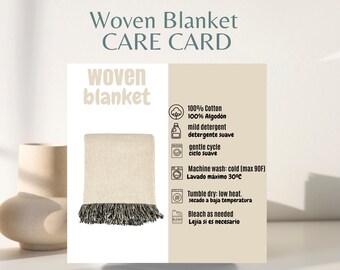 May include: A woven blanket with a cream-colored body and dark fringe is displayed next to a care card. The card includes care instructions such as machine wash cold (max 90F) and tumble dry low heat. The words "Woven Blanket CARE CARD" are at the top.