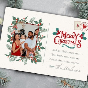 May include: A Christmas postcard with a family photo surrounded by a festive wreath. The words "Merry Christmas" are in red script with holly accents. The postcard includes space for a message and is signed "The Wilsons."