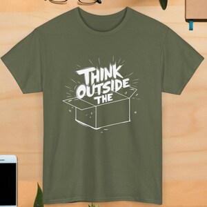 May include: A green t-shirt with the text "Think Outside The Box" in white lettering. The box is drawn in white and is open with the top of the box flipped up.