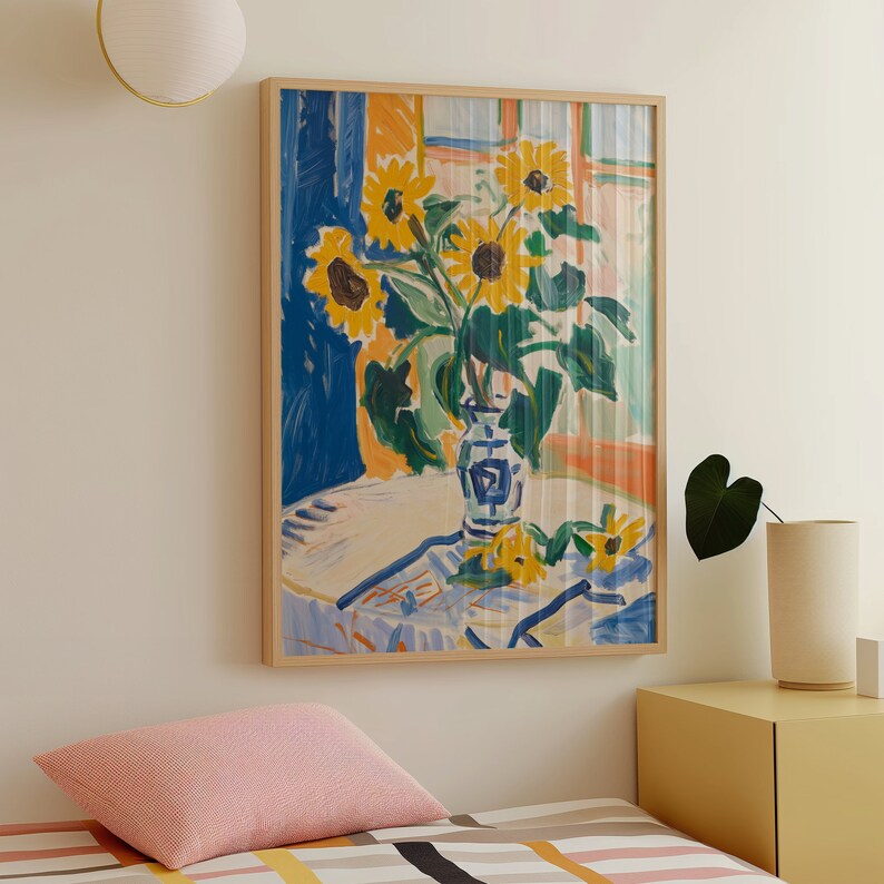 May include: A painting of a vase with sunflowers in a blue and white pattern. The vase is on a white table with a blue and white tablecloth. The background is a blue and white striped wall.
