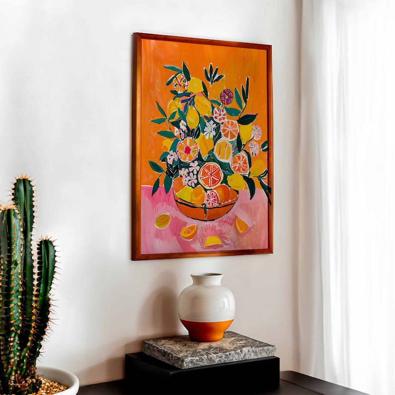 May include: A framed painting of a still life featuring a bowl of lemons and flowers on a pink background. The bowl is brown and the lemons are yellow with green leaves. The flowers are pink, white, and yellow.