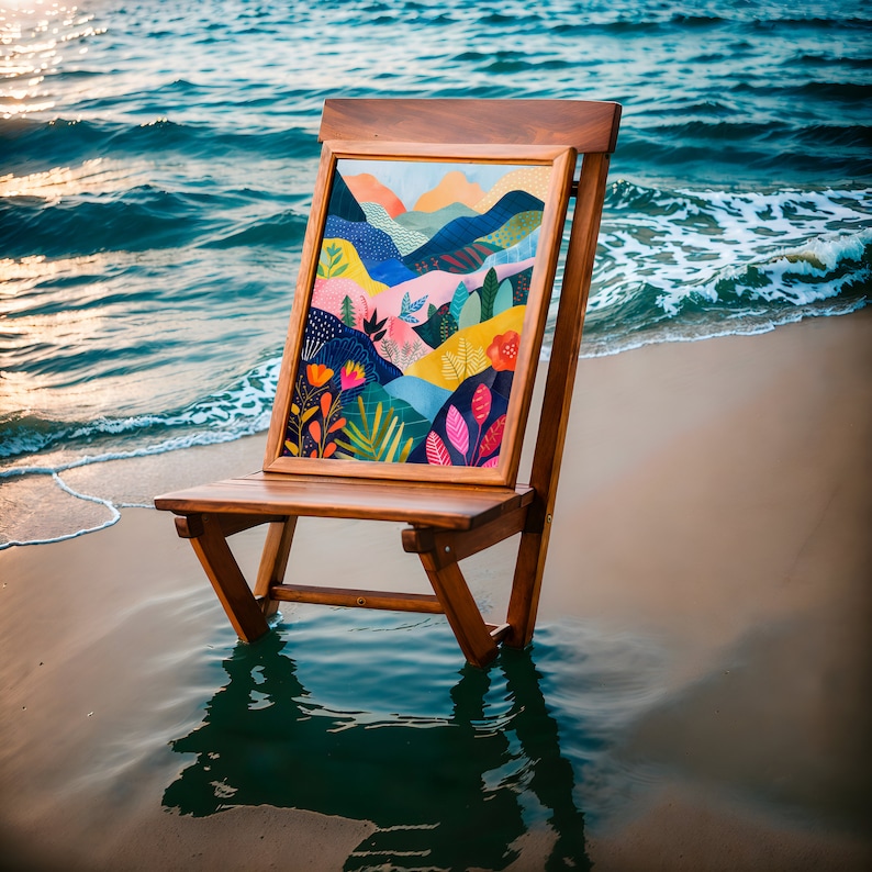 May include: A wooden beach chair with a colourful landscape painting in the backrest stands in shallow water. The artwork features mountains, trees, and flowers in shades of blue, orange, pink, and green. The chair is made of dark wood.