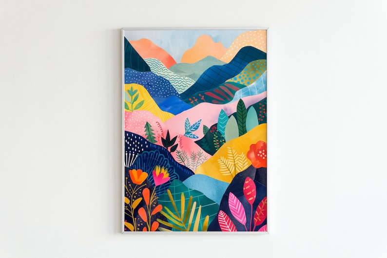 May include: A framed art print depicting a colourful abstract landscape. The artwork features rolling hills and foliage in shades of pink, yellow, blue, and orange. The frame is silver metal.