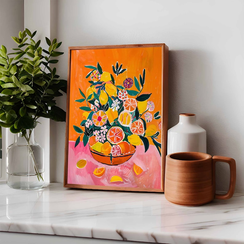 May include: A framed illustration of a bowl filled with lemons, limes, and oranges. The bowl is surrounded by green leaves and pink flowers. The background is a bright orange color.
