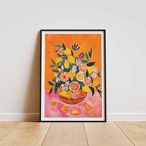 May include: A framed print of a painting featuring a bowl overflowing with lemons, oranges, and flowers. The bowl is on a pink surface with a bright orange background.