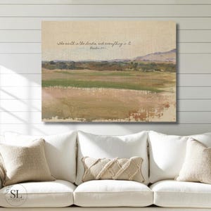 May include: An abstract landscape painting with a neutral color palette. The artwork features a field of green and brown hues, with a mountain range in the background. The text "The earth is the Lord's, and everything in it. Psalm 24:1" is written in a script font.