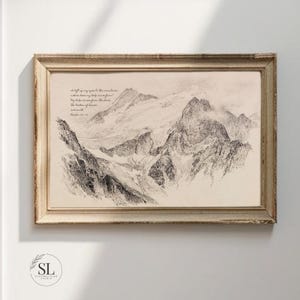 May include: A framed black and white mountain landscape print. The artwork features a detailed illustration of a mountain range with text at the top. The frame is a light brown color. The text reads: "I lift up my eyes to the mountains..." Psalm 121:1-2.