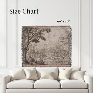 May include: A woven throw blanket featuring a sepia-toned landscape illustration with a large tree, a crowd of people, and a distant building. The text Size Chart and 60" x 50" are visible. The blanket has a fringed edge on all four sides.