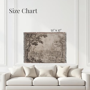 May include: A rectangular woven throw blanket featuring a sepia-toned landscape illustration with trees, figures, and a distant building. The text Size Chart and 52" x 37" are visible above the blanket, which has a fringed edge on all sides.