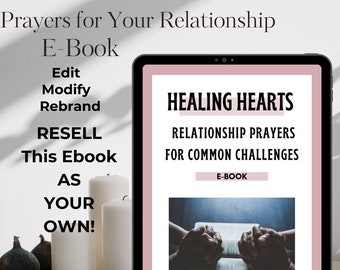 May include: A pink tablet screen displaying an ebook cover with the title "Healing Hearts: Relationship Prayers for Common Challenges". The cover features a photo of two hands clasped together over an open book. The text "E-Book" and "Gems to Jewels" are also visible on the cover.