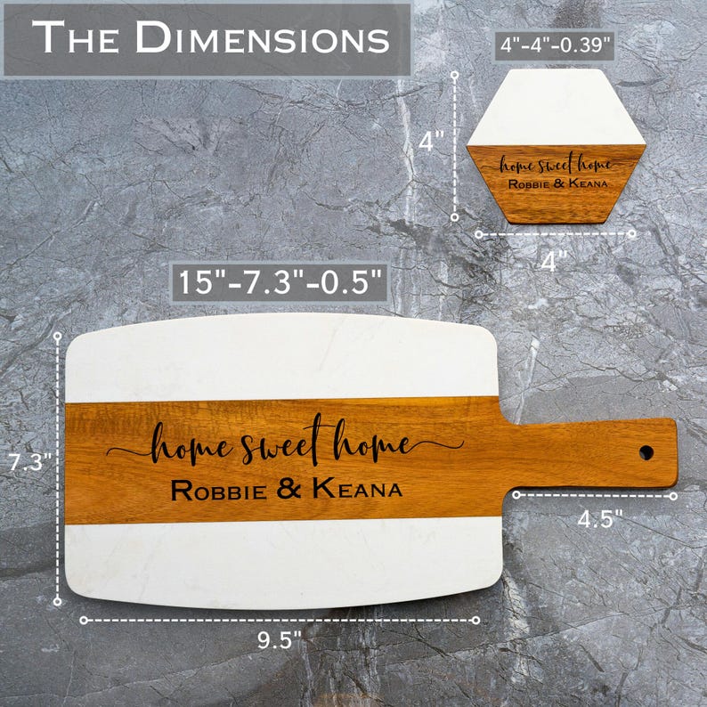 May include: A rectangular serving board made of white marble and brown wood, with a wooden handle. The board measures 15 inches long, 7.3 inches wide, and 0.5 inches thick. The board is engraved with the text "home sweet home Robbie & Keana".