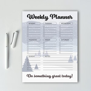 May include: A weekly planner with a winter theme. The top of the planner reads "Weekly Planner" in a script font. The days of the week are listed with checkboxes. The bottom of the planner reads "Do something great today!" A white pen is next to the planner.