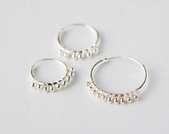 Stylish Circular Hoops Set - These Chic 925 Silver earrings, in four sizes, adorned with tiny silver decorative balls. Your everyday style