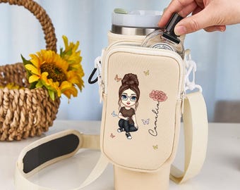 May include: A beige water bottle carrier with a shoulder strap and a small pouch. The pouch features a cartoon illustration of a woman, butterflies, and the name "Camelia". A basket of sunflowers is in the background.