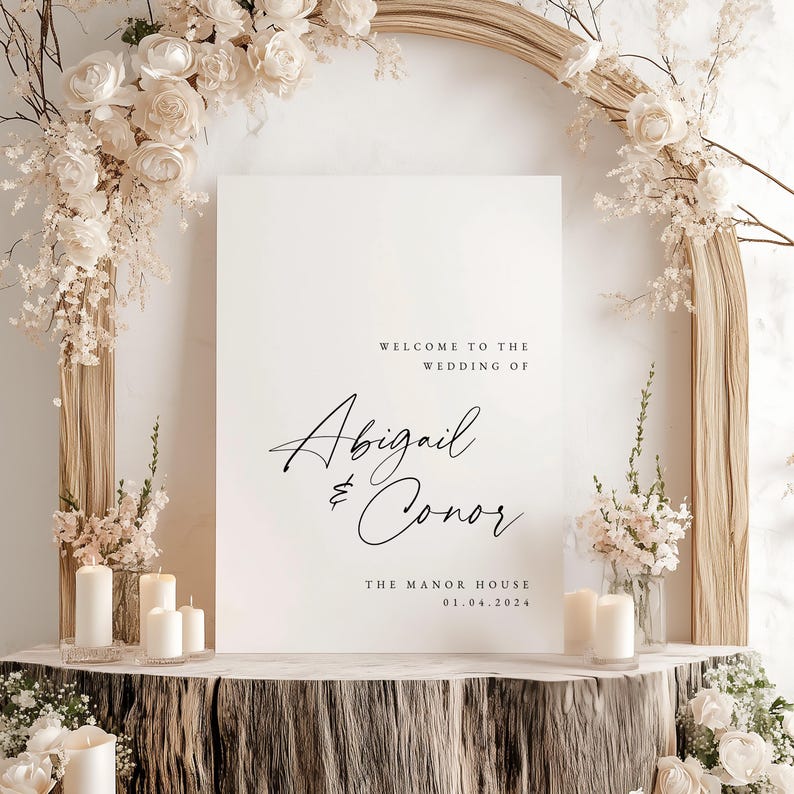 May include: White wedding welcome sign with black calligraphy text that reads "Welcome to the wedding of Abigail & Conor The Manor House 01.04.2024".