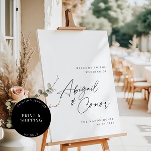 May include: White wedding welcome sign with black calligraphy text that reads "Welcome to the Wedding of Abigail & Conor" and "The Manor House 01.04.2024".