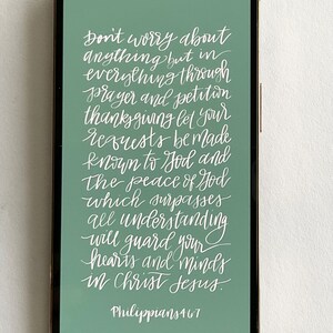 May include: A green phone screen with white text that reads "Don't worry about anything but in everything through prayer and petition thanksgiving let your requests be made known to God and The peace of God which surpasses all understanding will guard your hearts and minds in Christ Jesus. Philippians 4:6-7"