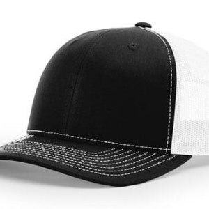 May include: A black and white trucker hat with a black front panel and a white mesh back panel. The hat has a curved brim and a white stitching detail around the brim.