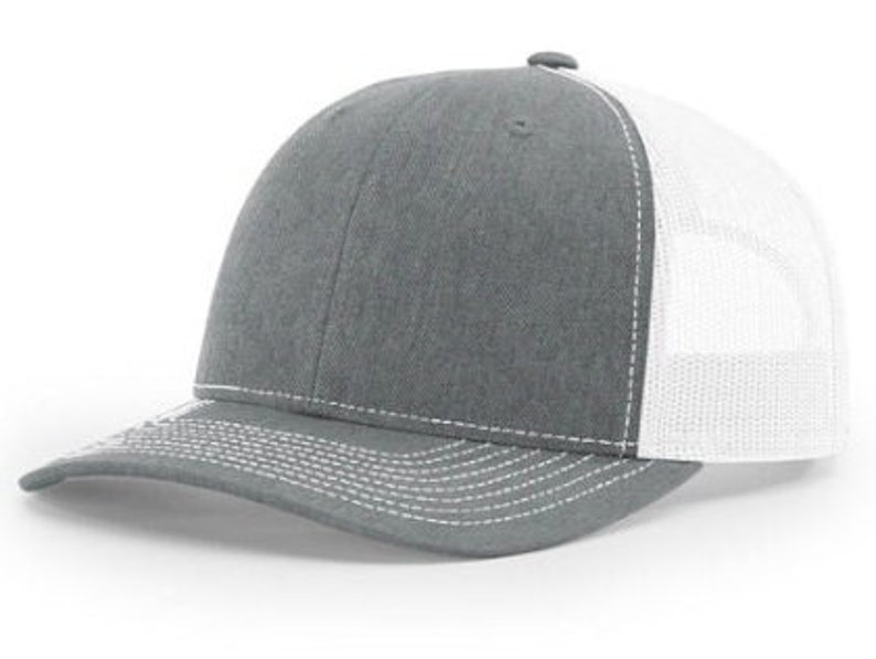 May include: A gray and white trucker hat with a mesh back. The hat has a curved brim and a white stitching detail.
