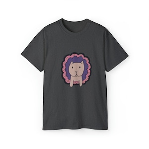 May include: A dark gray t-shirt with a cartoon illustration of a cat wearing a pink collar and a purple flower crown.