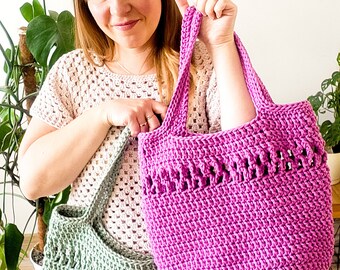 May include: Two crocheted tote bags, one green and one pink, with a woven pattern. The bags have a wide, flat base and a single handle.