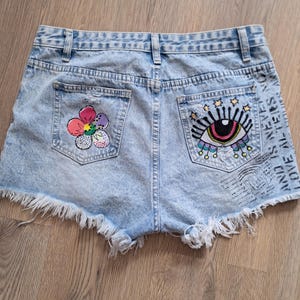 Hand-Painted Denim Shorts – Eye & Flower Design