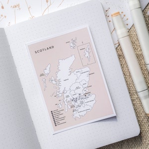 May include: A map of Scotland with the regions labeled and numbered. The map is printed on a light pink background and is surrounded by a white border. The map is titled "Scotland" in black text.
