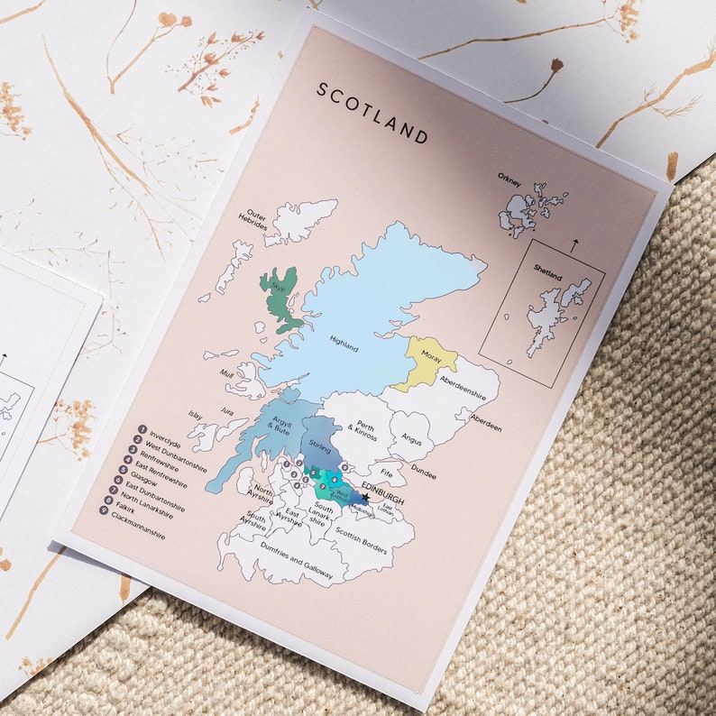 May include: A map of Scotland with the regions highlighted in different colors. The map includes the names of each region and the major cities. The map is printed on a light pink background.