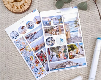 May include: Two sheets of stickers featuring images of Crete, Greece. The stickers are white with a blue and white Greek flag design. The first sheet is labelled "Crete 1" and features images of a beach, a harbour, a tiled floor, and a building. The second sheet is labelled "Crete 2" and features images of a building, a street, a beach, and a tiled floor.