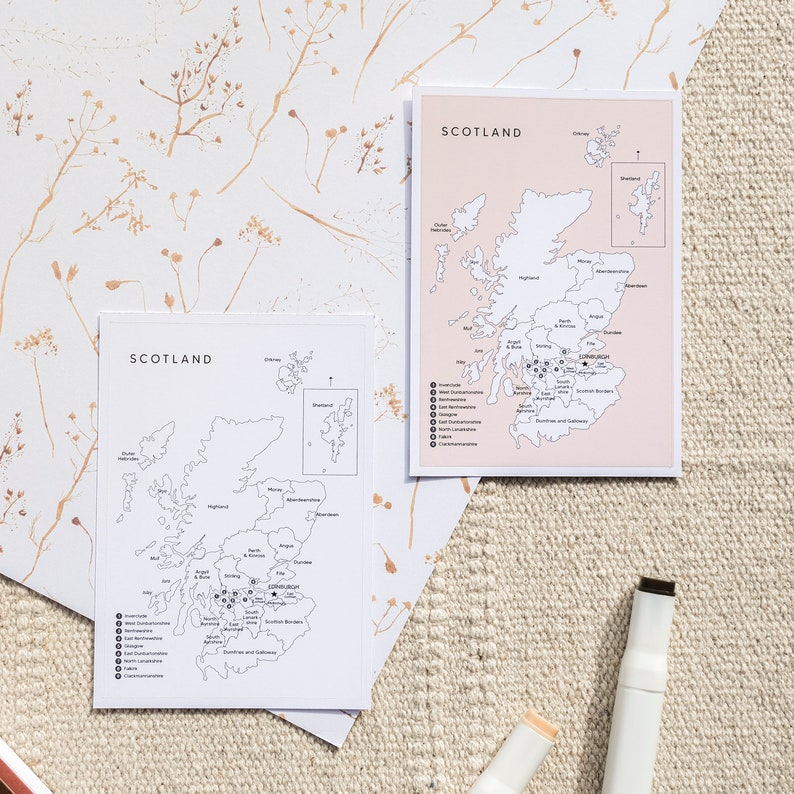 May include: Two printable maps of Scotland with a pink background and black lines. The maps show the regions of Scotland and the cities. The maps are on a white surface with brown floral designs.