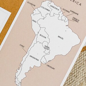 May include: A black and white outline map of South America with the names of each country labeled. The map is on a light pink background.