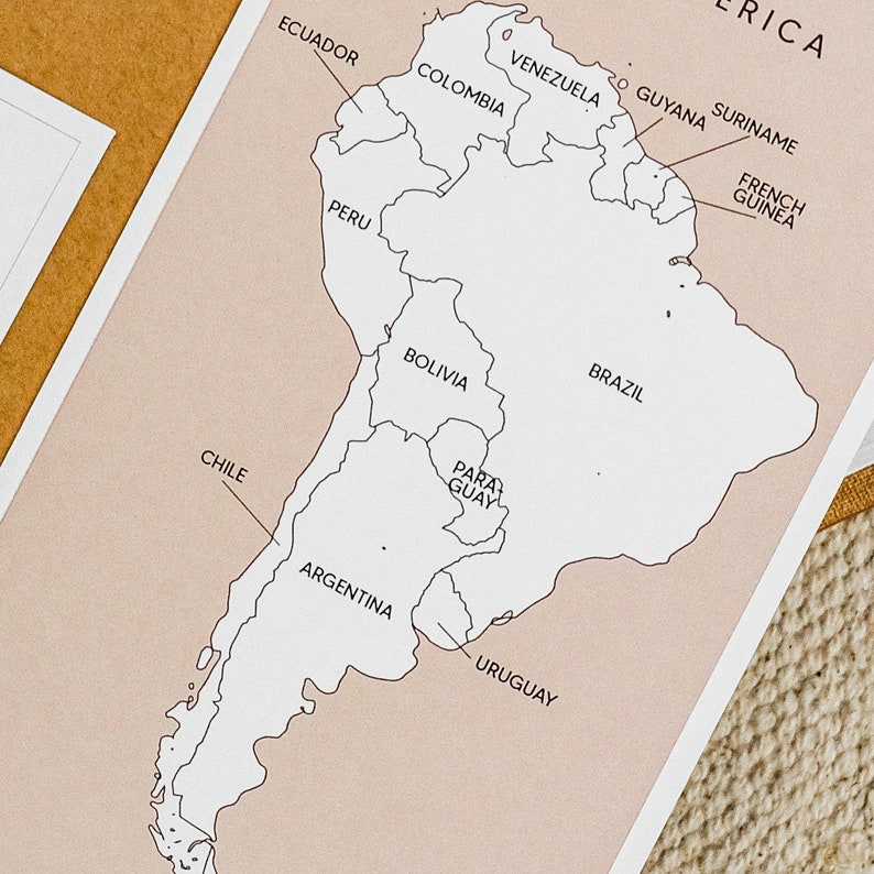 May include: A black and white outline map of South America with the names of each country labeled. The map is on a light pink background.