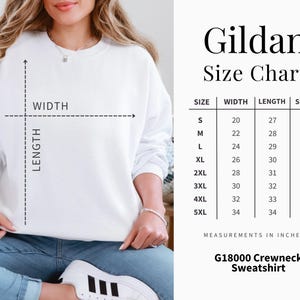 May include: A white Gildan crewneck sweatshirt with a size chart. The chart lists measurements in inches for width, length, and sleeve length, ranging from size small to 5XL. The sweatshirt is G18000.