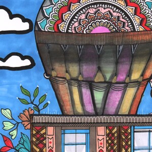 Peut inclure: Illustration color&eacute;e d'une montgolfi&egrave;re avec un motif mandala d&eacute;taill&eacute;. Le ballon est au-dessus d'un b&acirc;timent avec des fen&ecirc;tres et des accents floraux, sur fond de ciel bleu avec des nuages. L'&oelig;uvre utilise des couleurs vives.