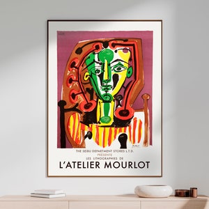 May include: A vintage poster with a colorful abstract portrait of a woman in red, yellow, green, and black. The poster is titled "L'Atelier Mourlot" and features the text "The Seibu Department Stores Ltd. Presents Les Lithographies de".
